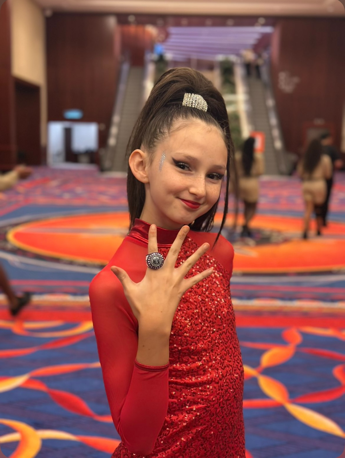 Hadley in her pom uniform with her championship ring